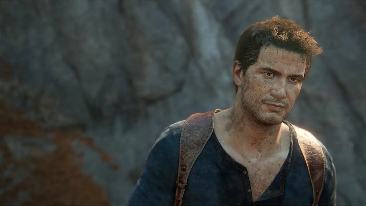 Nathan Drake clinging to a jeep on a muddy hillside in Uncharted: Legacy of Thieves Collection