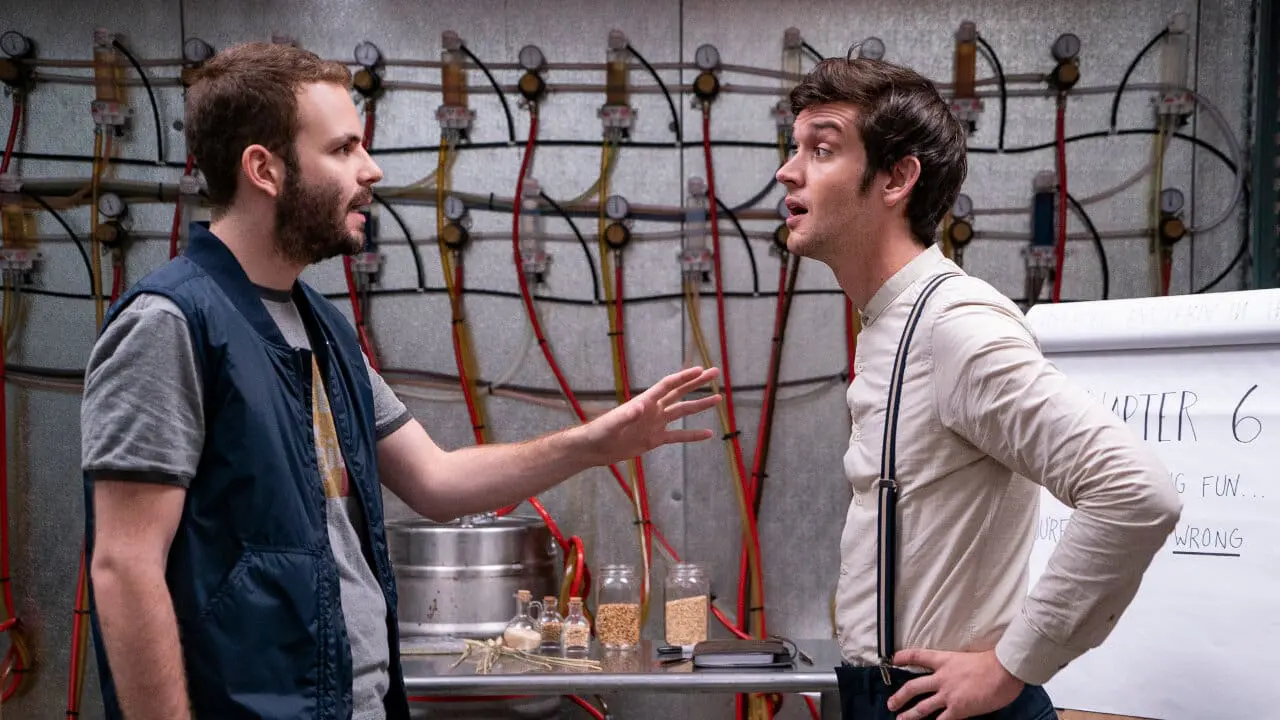 Wilhelm and Adam in their taproom at Rodman’s Brewery, surrounded by tanks and glasses of beer.