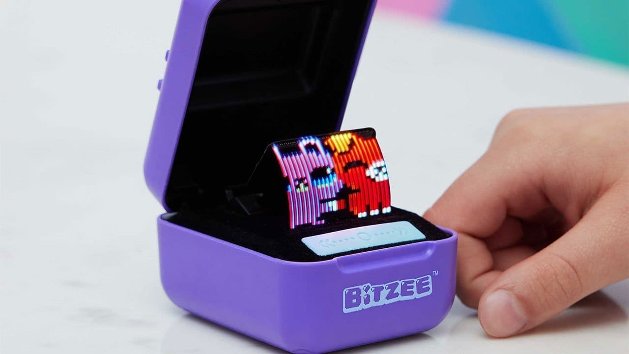 Bitzee handheld digital pet greeting the user with a pixel dog saying 'Hurro!'
