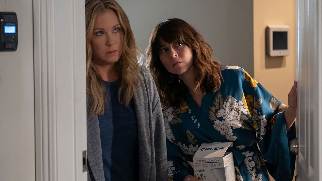 Judy and Jen peeking through blinds