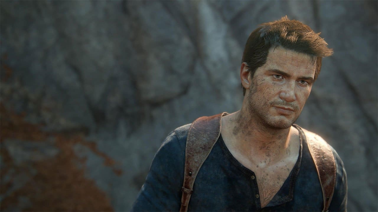 Nathan Drake clinging to a jeep on a muddy hillside in Uncharted: Legacy of Thieves Collection